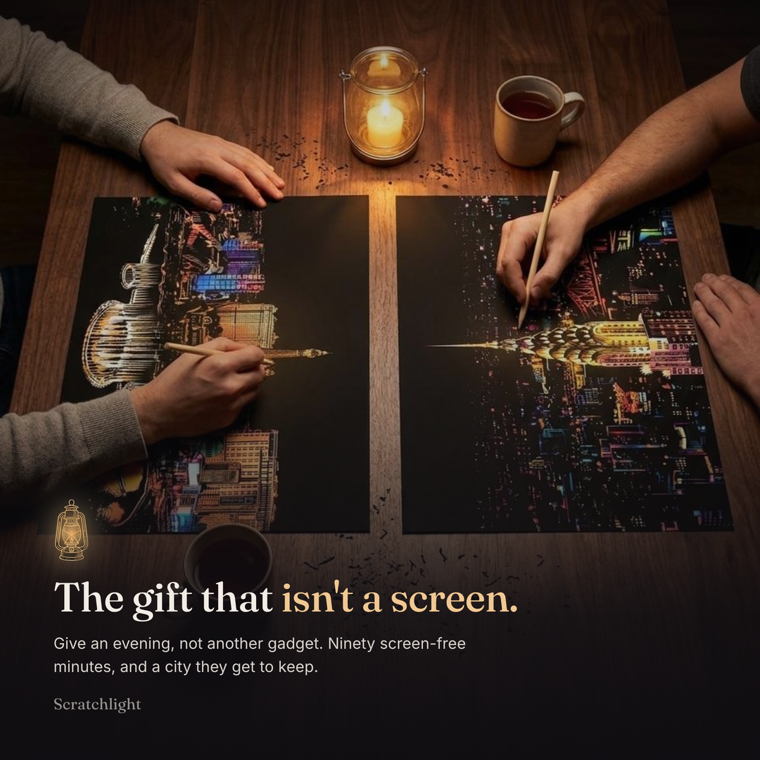 The gift that is not a screen: two people scratching their city cards together by candlelight. Give an evening, not another gadget, and a city they get to keep.